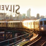 Long Island City, No. 7 train rounding the bend with the Silvercup sign and the NYC skyline in the background.